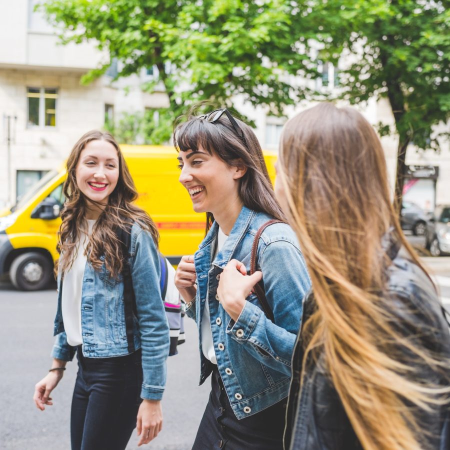 Three young beautiful caucasian millennials women walking outdoor in the city